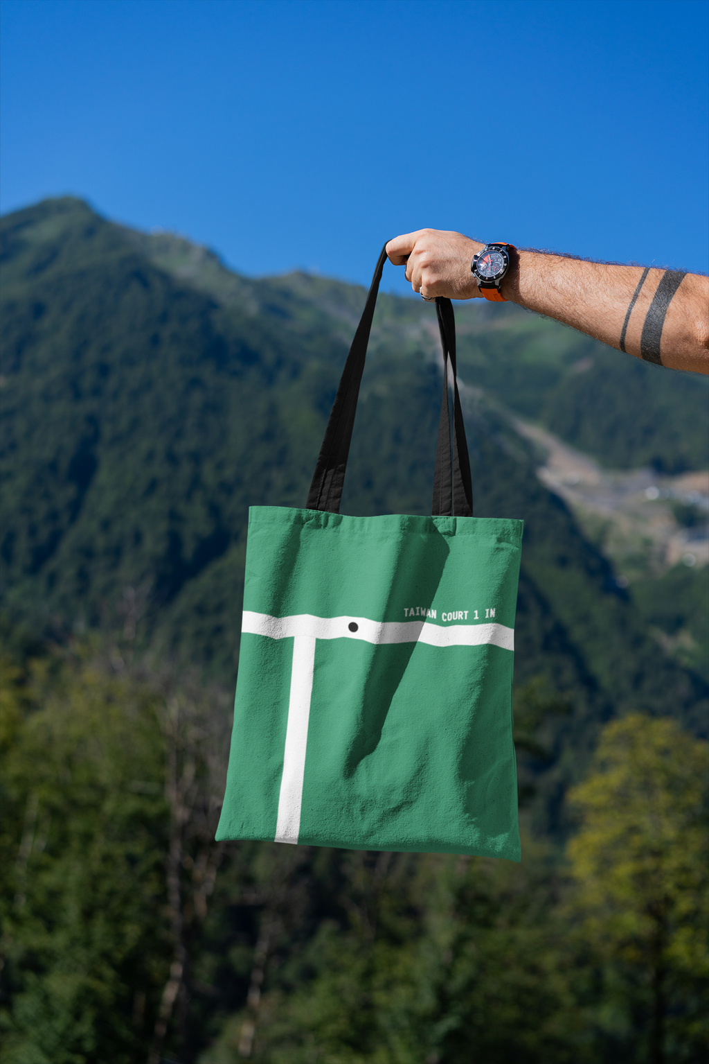 mockup-featuring-a-man-s-hand-holding-a-tote-bag-against-a-natural-scenery-3131-el1 (31).png