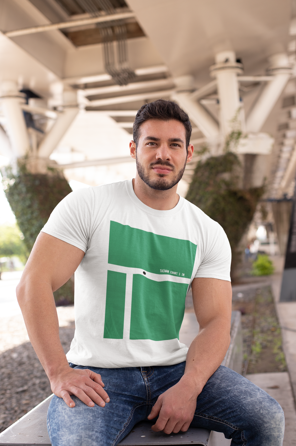 t-shirt-mockup-of-a-muscular-man-sitting-on-a-bench-in-the-city-28516.png