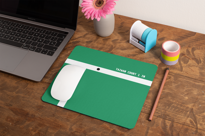 mockup-of-a-mousepad-lying-on-a-rustic-table-next-to-a-flower-vase-27554.png