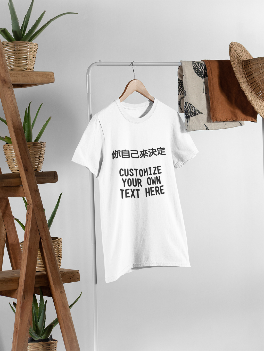 tee-mockup-hanging-from-a-rack-next-to-wooden-furniture-with-plant-pots-27400.png