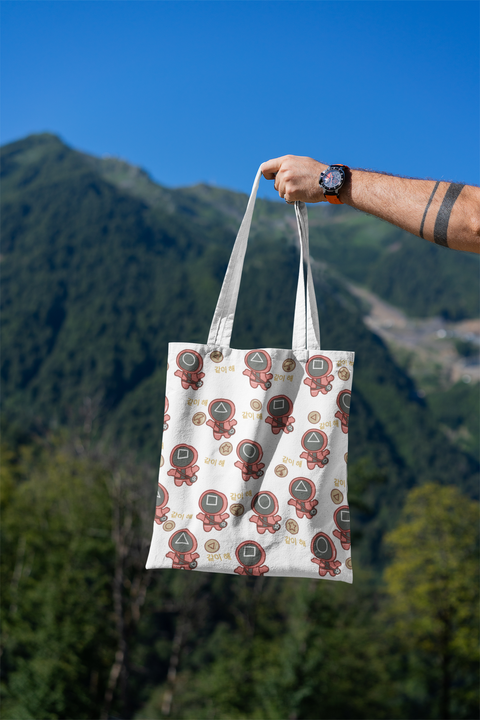 mockup-featuring-a-man-s-hand-holding-a-tote-bag-against-a-natural-scenery-3131-el1.png