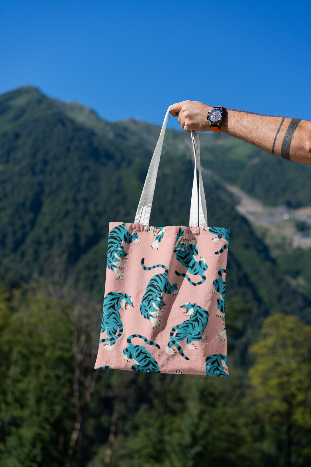 mockup-featuring-a-man-s-hand-holding-a-tote-bag-against-a-natural-scenery-3131-el1 (1).png