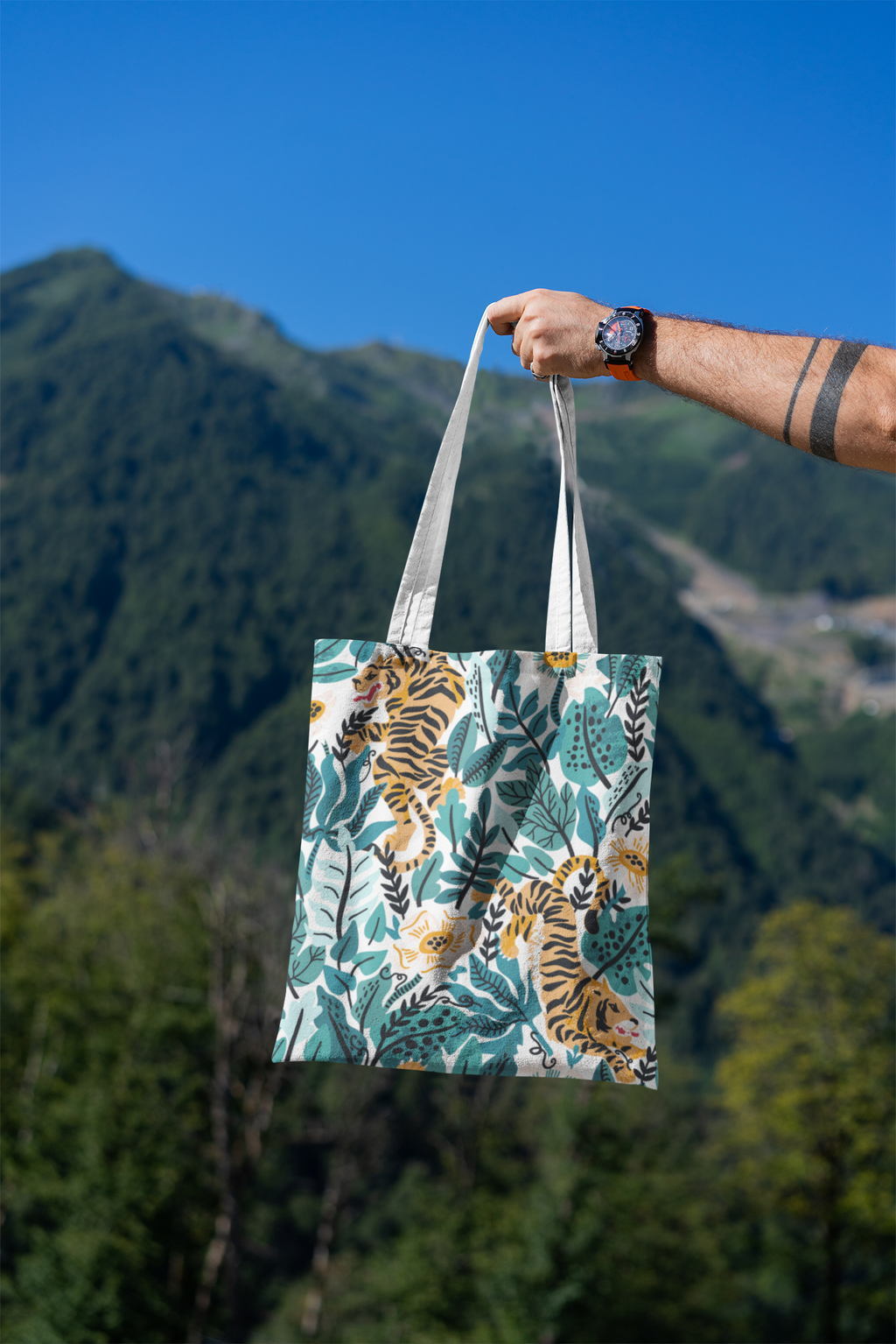 mockup-featuring-a-man-s-hand-holding-a-tote-bag-against-a-natural-scenery-3131-el1 (2).png