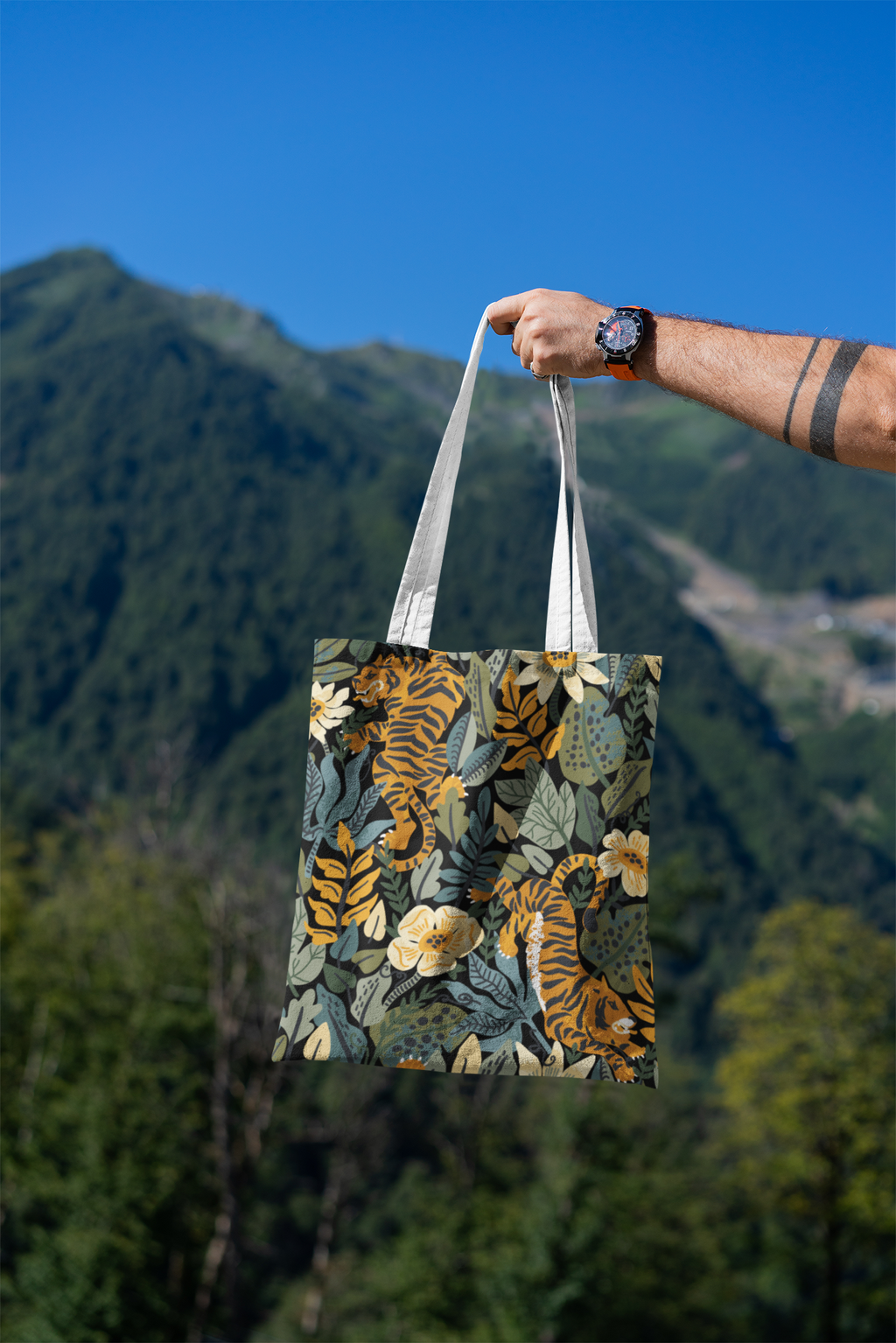 mockup-featuring-a-man-s-hand-holding-a-tote-bag-against-a-natural-scenery-3131-el1 (3).png