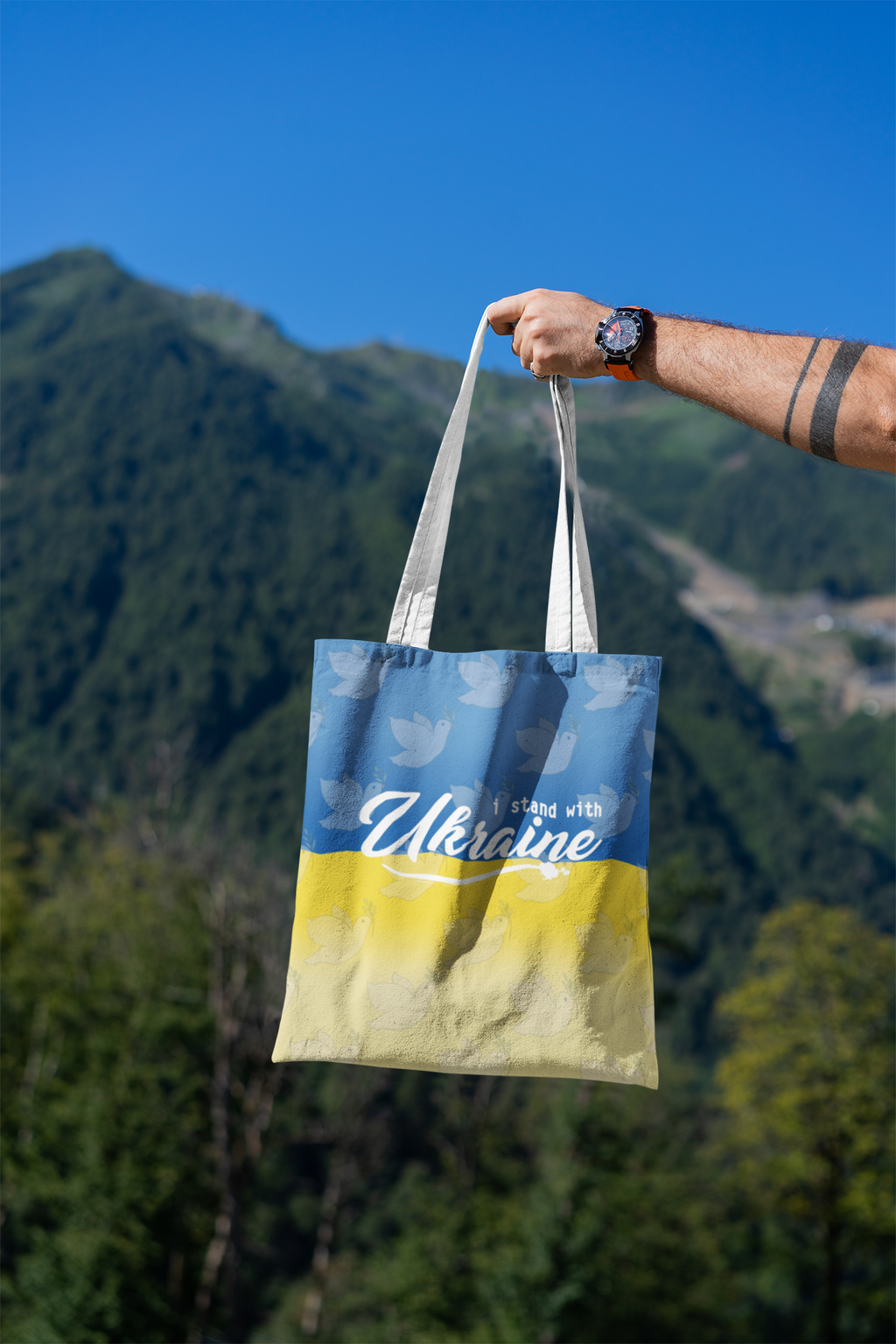 mockup-featuring-a-man-s-hand-holding-a-tote-bag-against-a-natural-scenery-3131-el1 (10).png