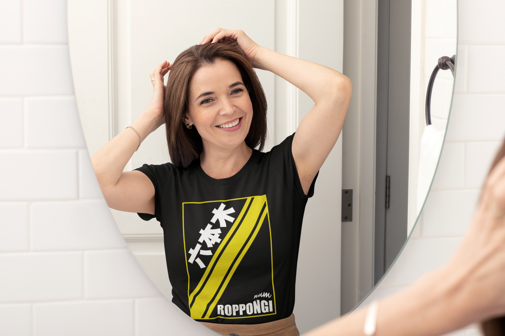 mockup-of-a-happy-middle-aged-woman-wearing-a-t-shirt-and-looking-herself-in-the-mirror-31607.png