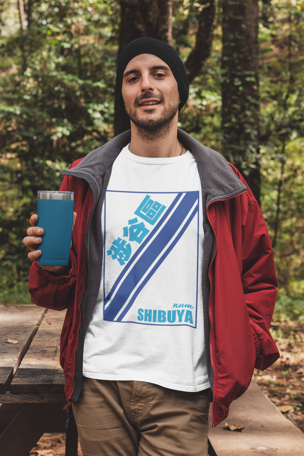 t-shirt-mockup-featuring-a-man-holding-a-20-oz-travel-mug-in-the-woods-30486.png