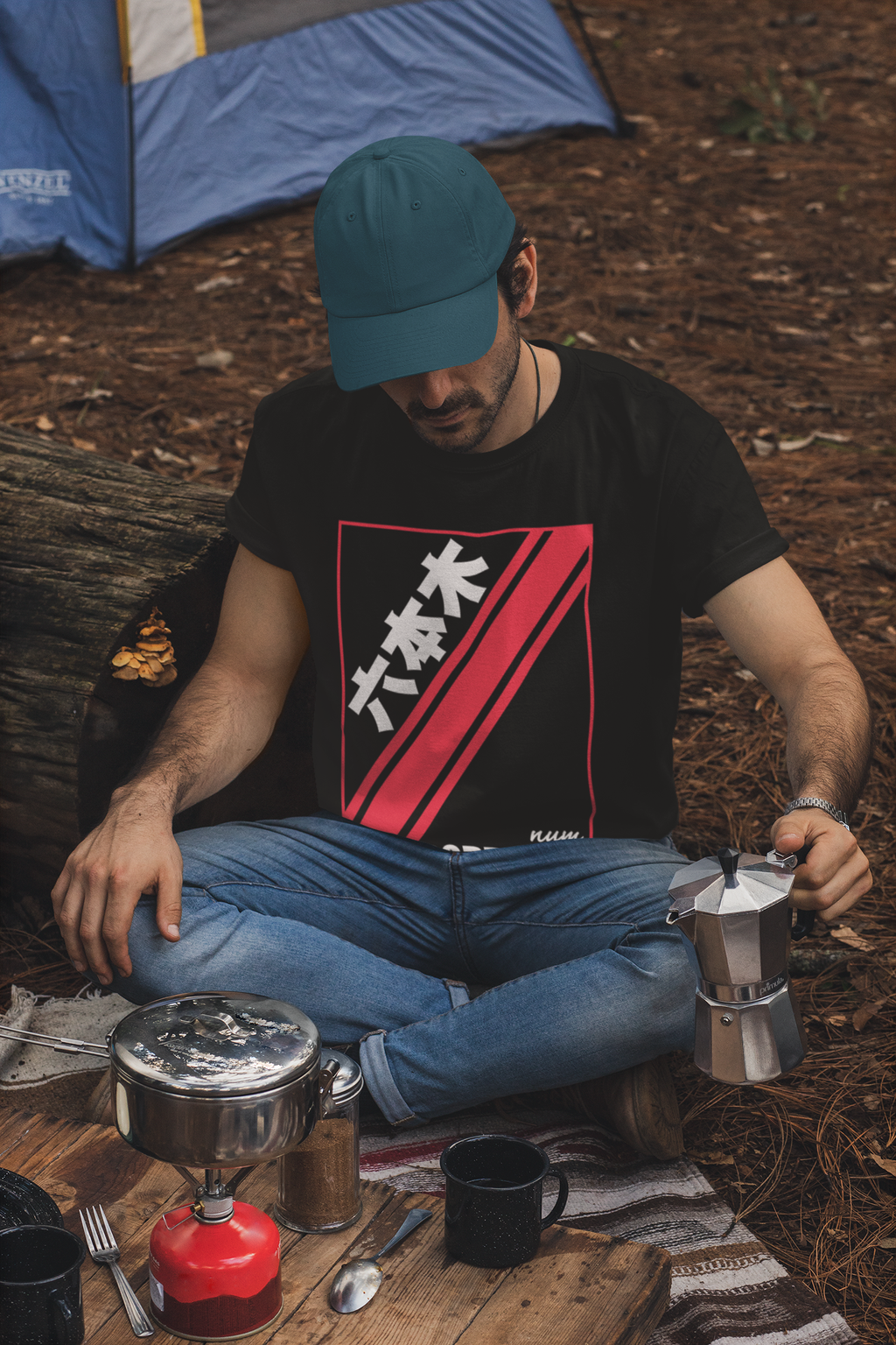 t-shirt-and-dad-hat-mockup-of-a-man-making-coffee-in-a-camping-site-30476.png