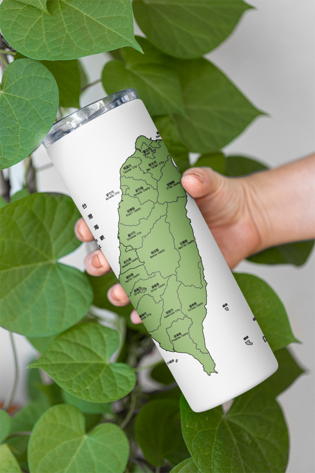 mockup-of-a-skinny-tumbler-being-held-by-a-woman-featuring-some-leaves-m21472.png