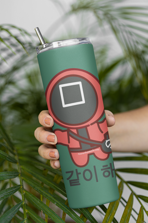 mockup-of-a-woman-holding-a-skinny-tumbler-featuring-palm-leaves-in-the-background-m21468.png