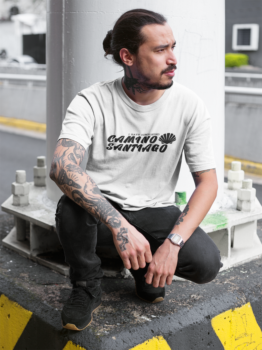 tattooed-man-wearing-a-round-neck-tee-mockup-while-crouching-under-a-bridge-a17078