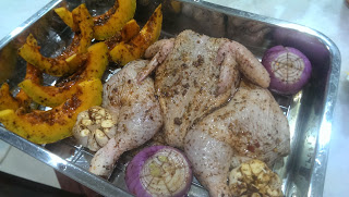 Marinated chicken and pumpkin on cookie rack ready for roasting