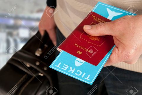 50363840-customs-control-passport-and-ticket-in-hand-in-airport.jpg