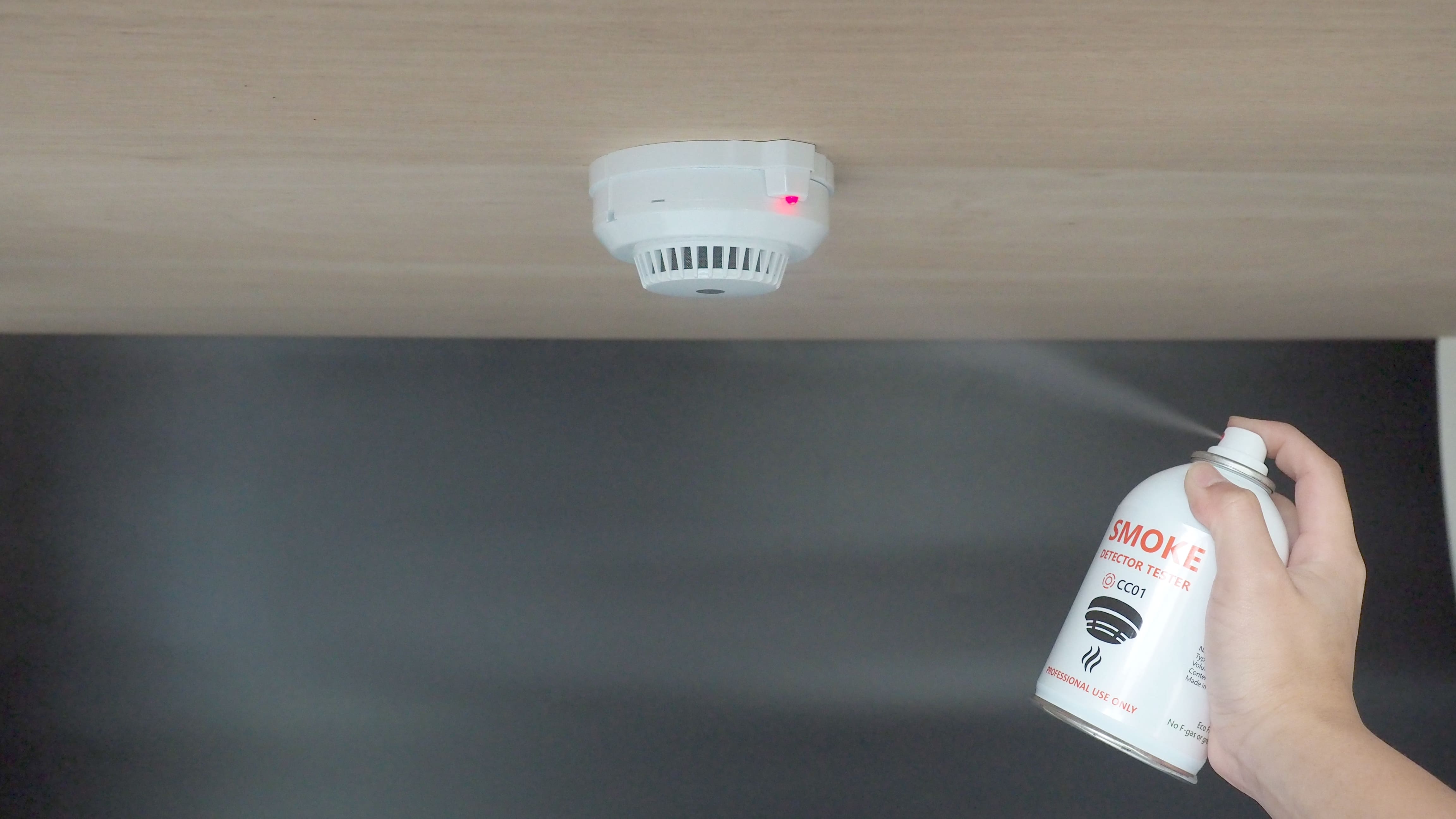 testing fire alarm with smoke detector tester spray.jpg