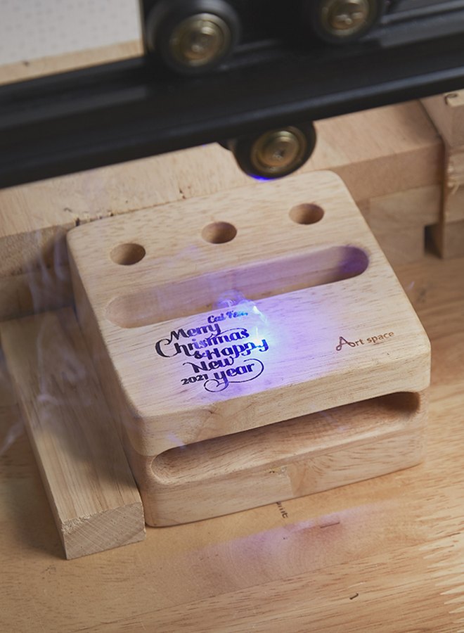 Laser engraving on a wooden phone stand