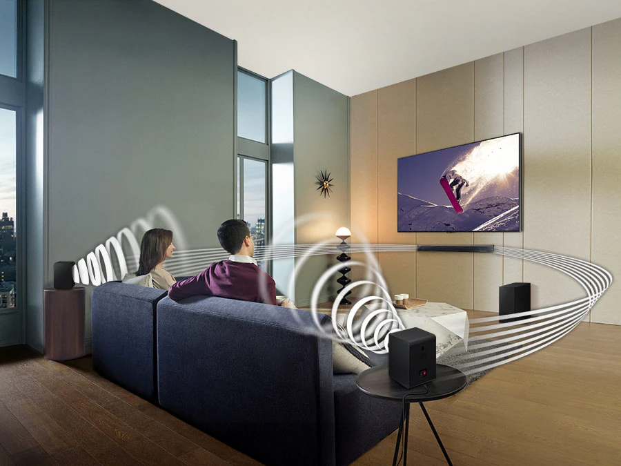 Description: Family watches animation in immersive surround sound with Samsung Wireless Rear Speaker Kit and Soundbar activated together.