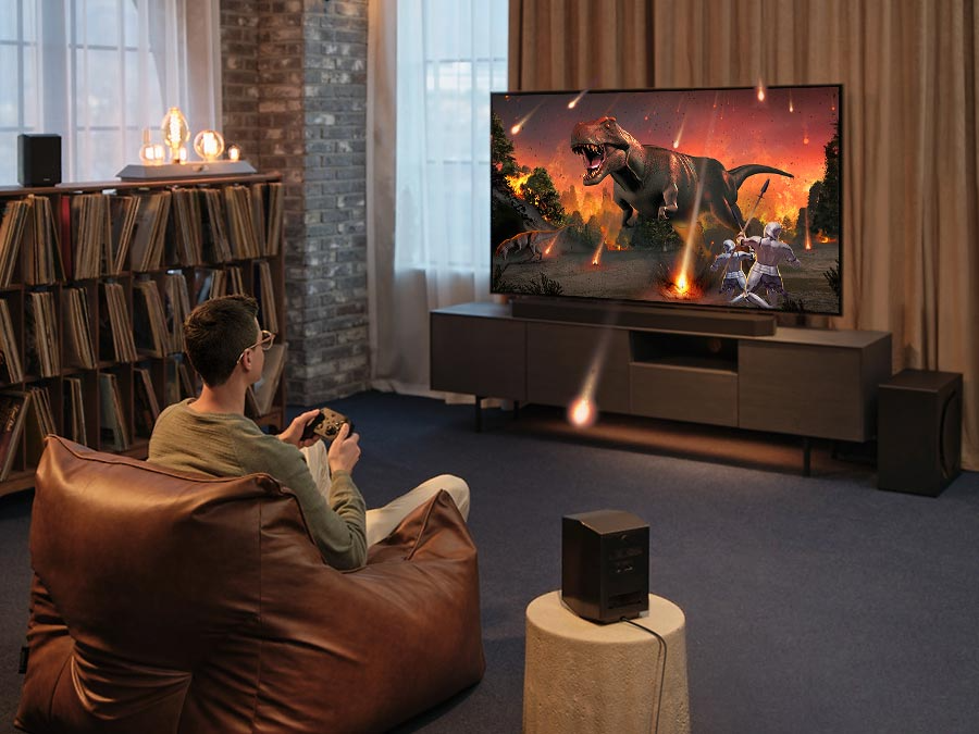 Description: A man enjoys an immersive 3D-like gaming experience with Samsung Soundbar Game Mode Pro.