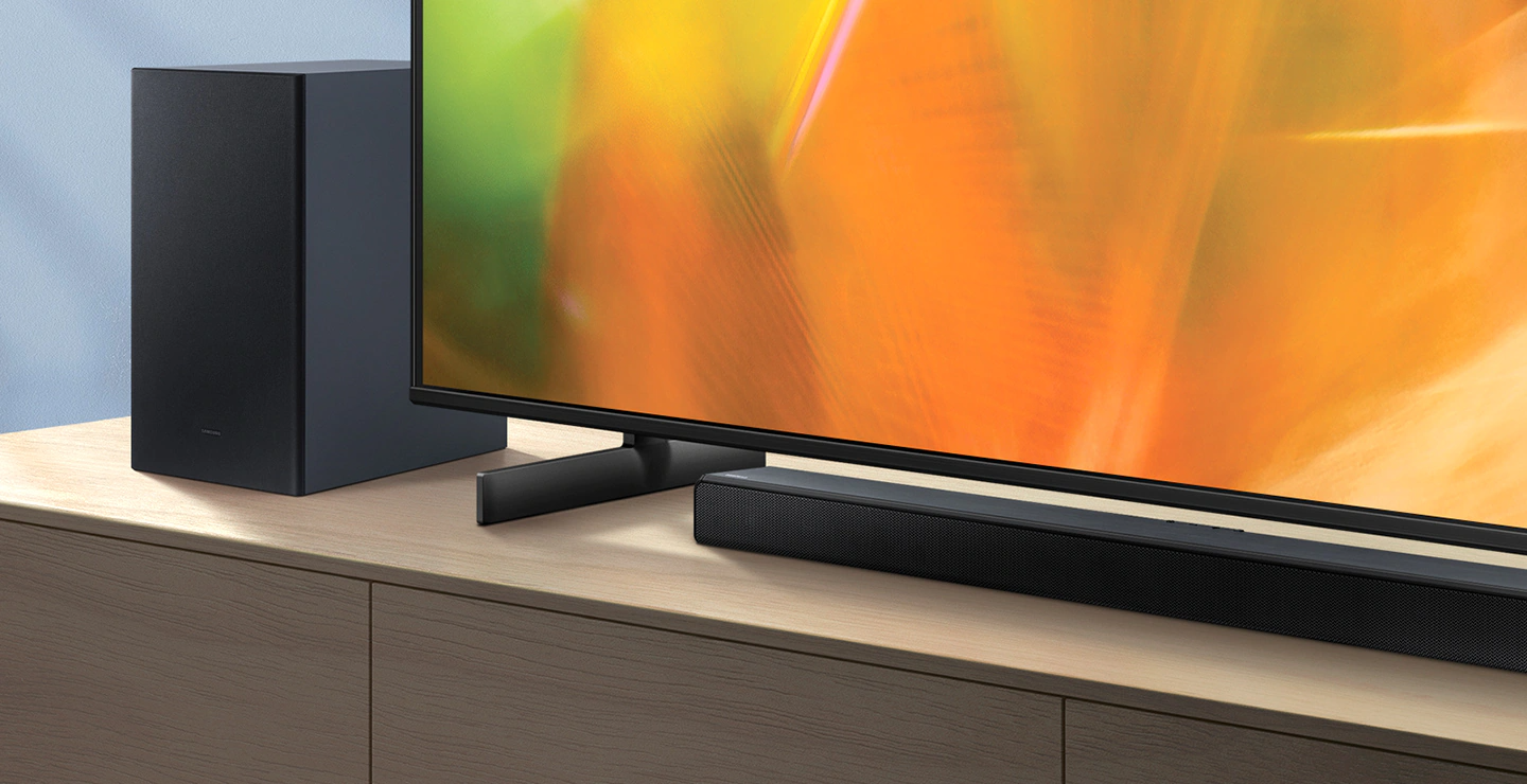 A series Soundbar and subwoofer are positioned next to Crystal UHD TV.