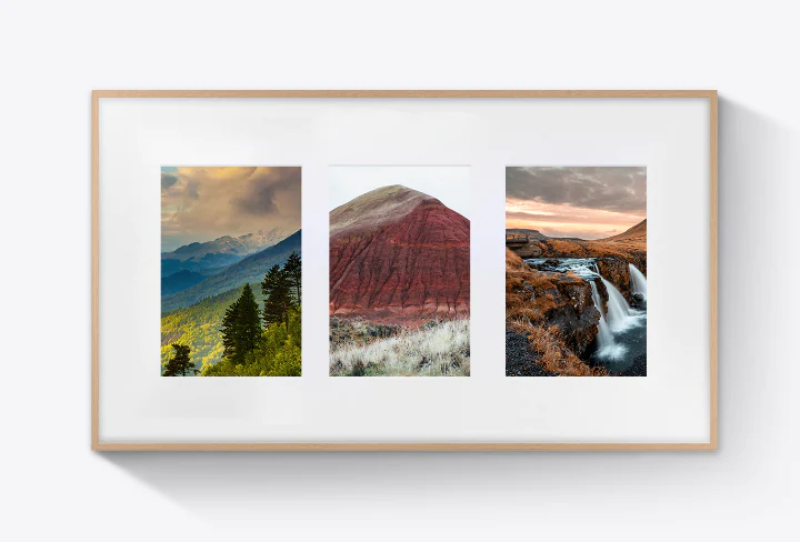 Three artworks are evenly laid out on top of one of The Frame's Mat Canvas options.