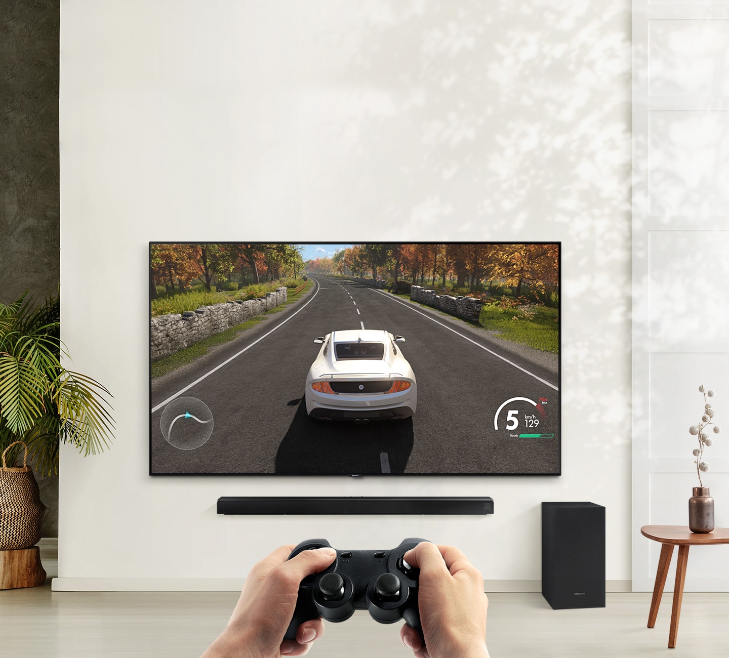Description: A user is enjoying soundbar’s Game Mode while playing a racing game on their TV connected to soundbar and subwoofer.