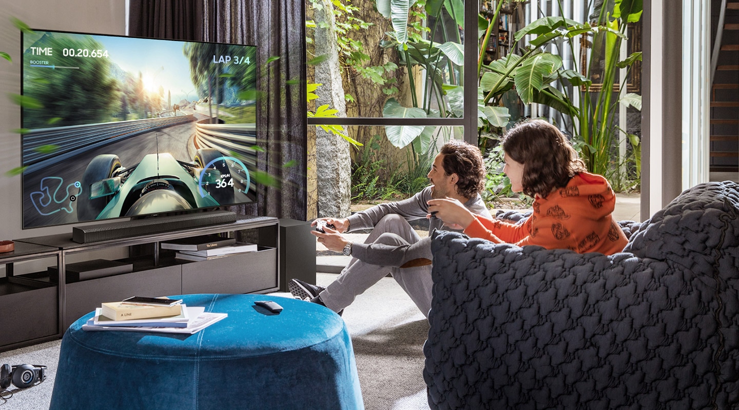 Description: Two friends are enjoying an immersive gaming experience with Samsung Soundbar Game Mode Pro.