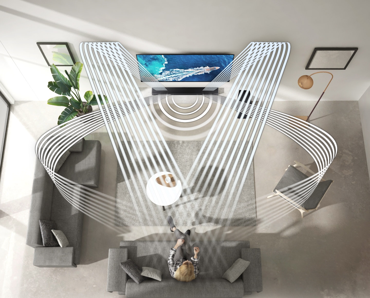 Description: Various soundwave graphics coming from soundbar illustrate how the woman enjoying QLED TV in her living room experiences sound created by Samsung Acoustic Beam. 2 soundwave graphics are up-firing from the top of the soundbar and toward the woman. 3 soundwave graphics are coming from the side and center of the soundbar and toward the woman.