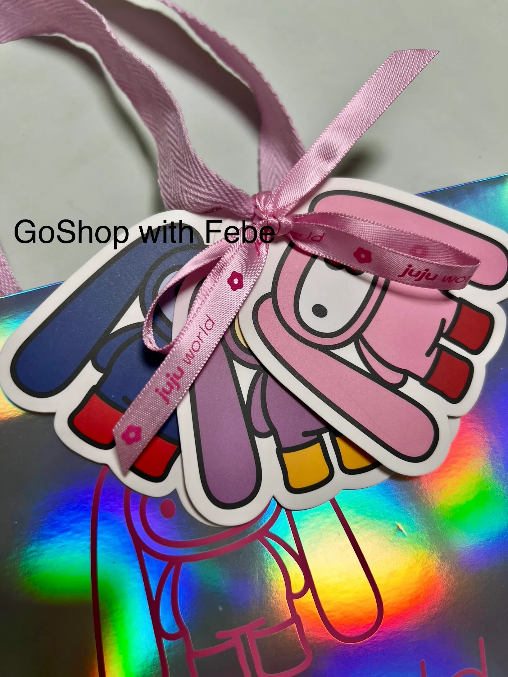 Detail view of official JuJu tag attached to JuJu World event paper bag