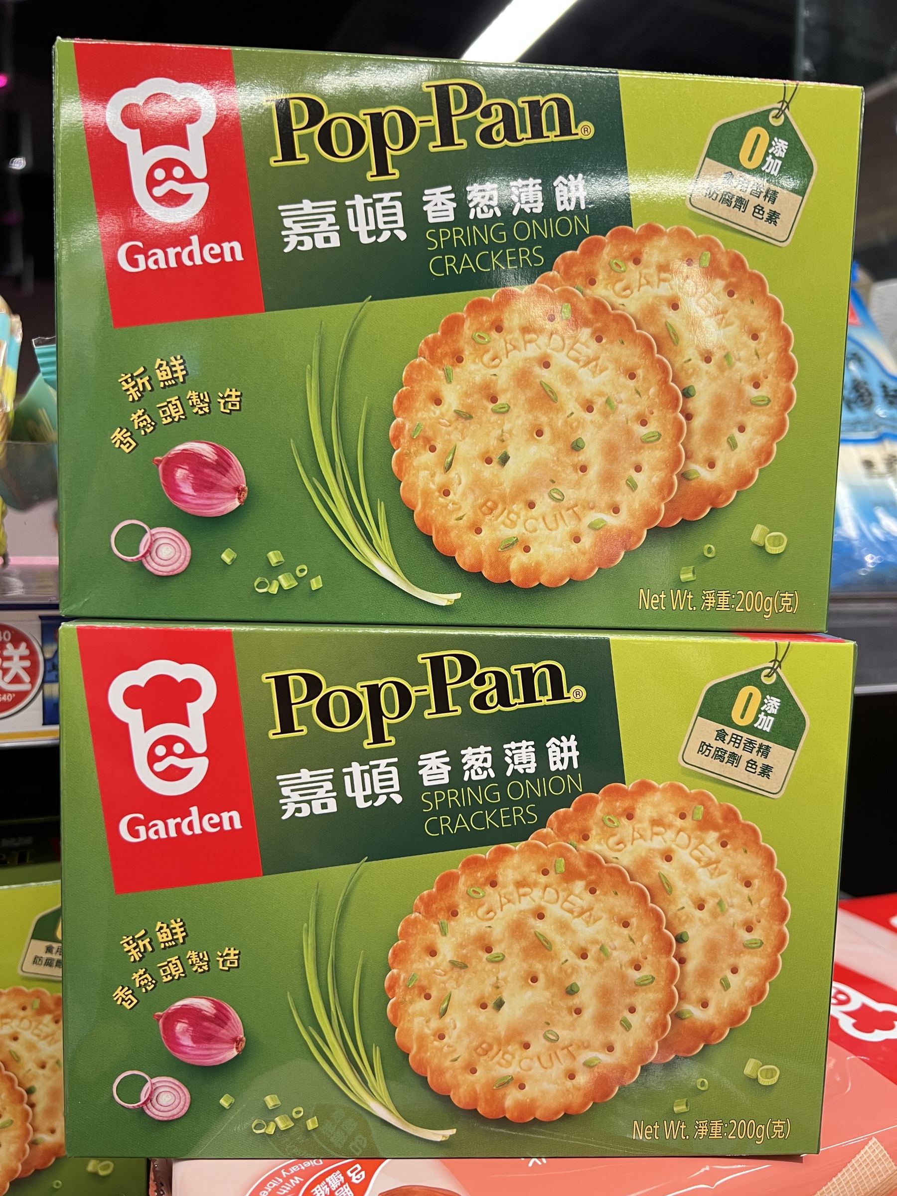 Crispy, thin savory biscuits with visible green spring onion flakes and sesame seeds