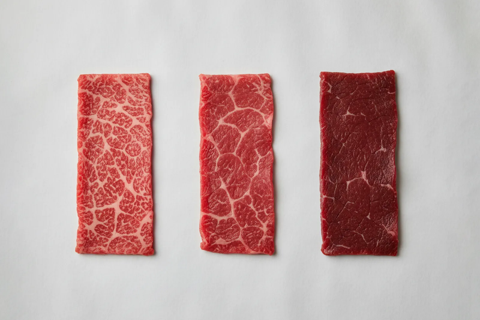 Three lean beef strips from bright to deeper red illustrating myoglobin increase with age.