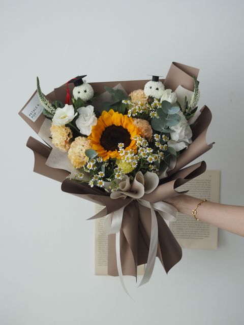 Sunflower with pink eustoma and matricaria together with Graduation guy and bunny - RM228