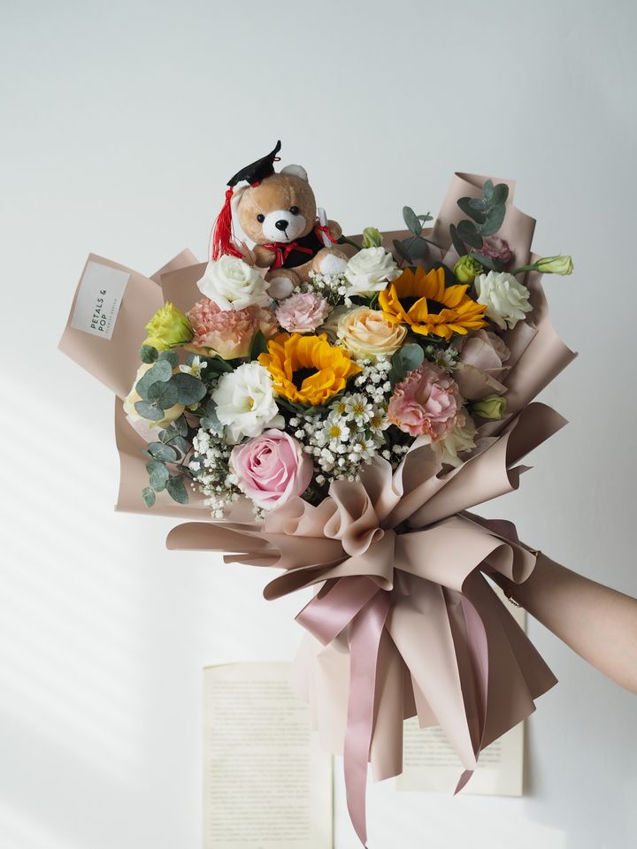 mix it with pink roses and sunflower, together with hana and baby breath with ping pong and foliage (medium size) with bear - RM258