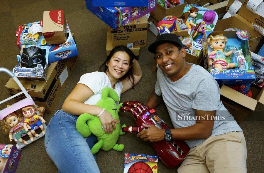 Arvinthan Rengaraju and his wife, Chan Heng Leng, posing with some of the toys at their office in Dataran Prima, Petaling Jaya