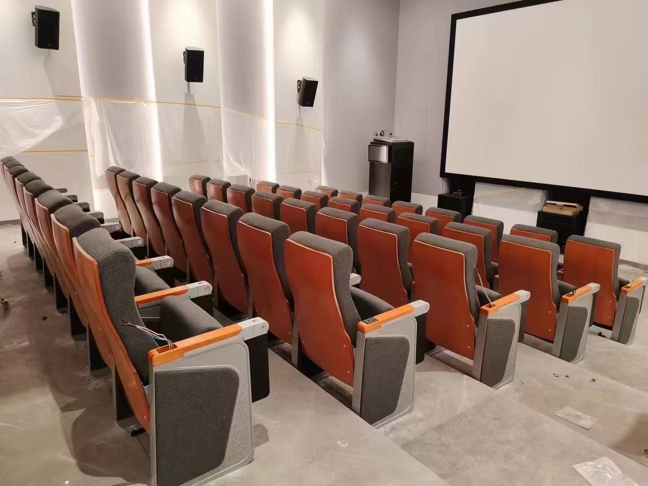 a row of auditorium chair with usb charging ports