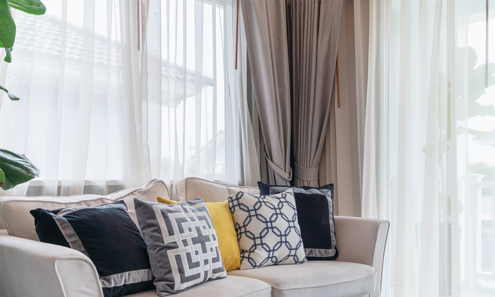 Elegant brown drapes with white curtains in living room 