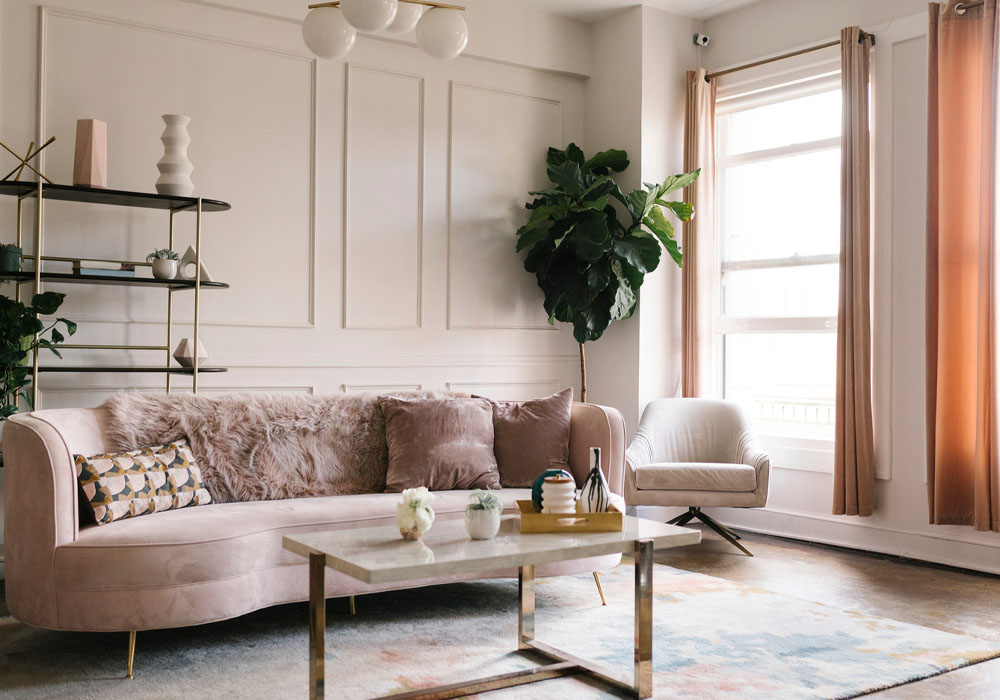 White marble gold steel leg coffee table with pink couch in living room