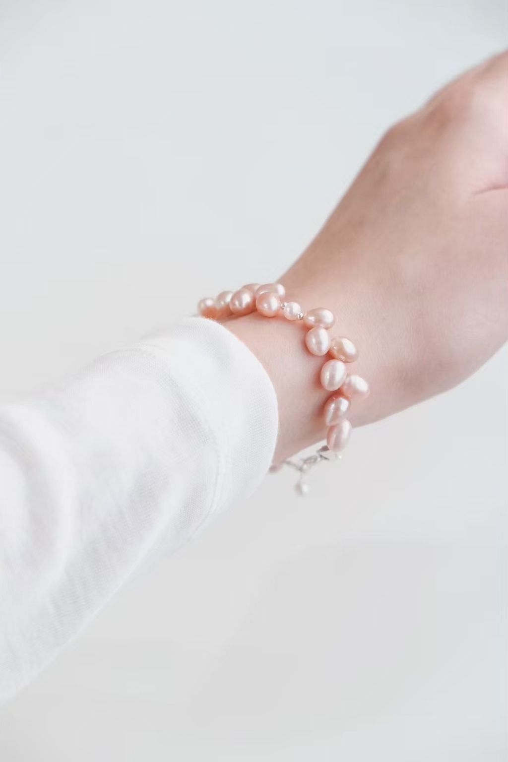 pink-rice-pearl-bracelet-on-wrist.jpg