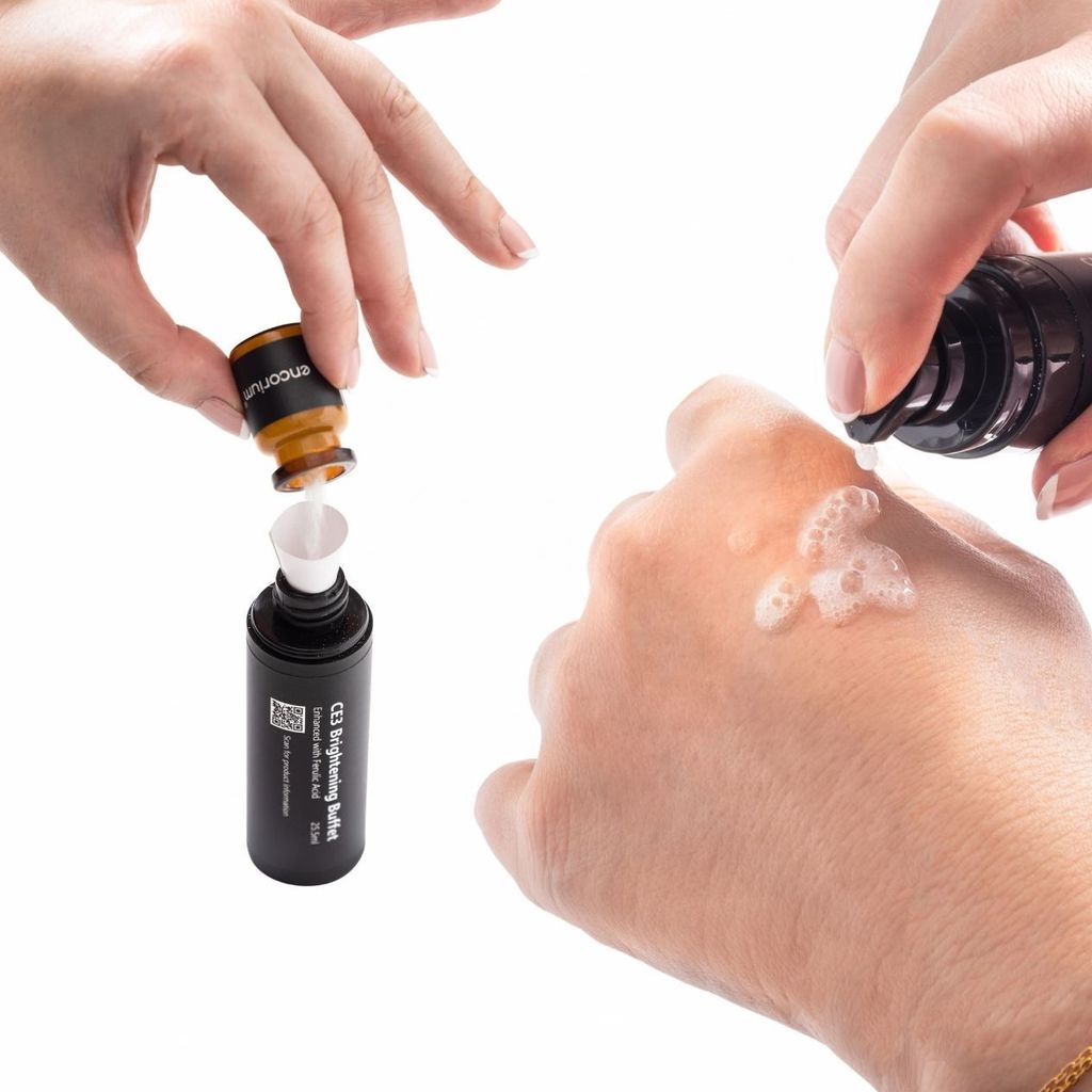 Mixing the C+ Activator into Encorium CE3 Brightening Buffet, then applying the serum to the back of a hand.