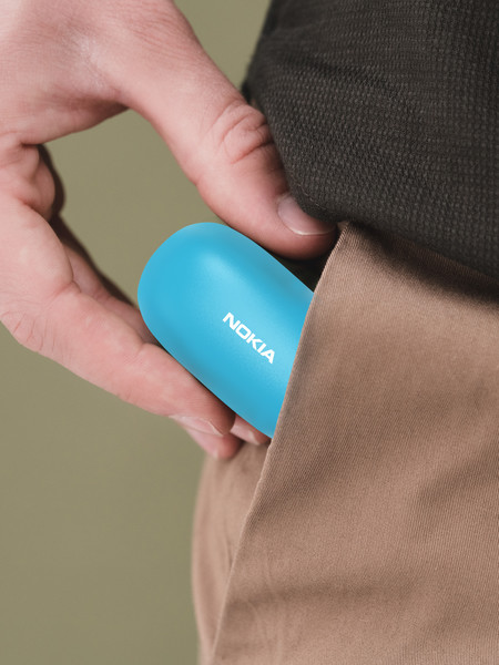 a men putting a blue color nokia E3100 essential true wireless earphones into his pocket