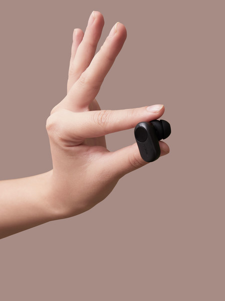 a hand holding up one Nokia Professional True Wireless Earphones P3802A,  the size is very small