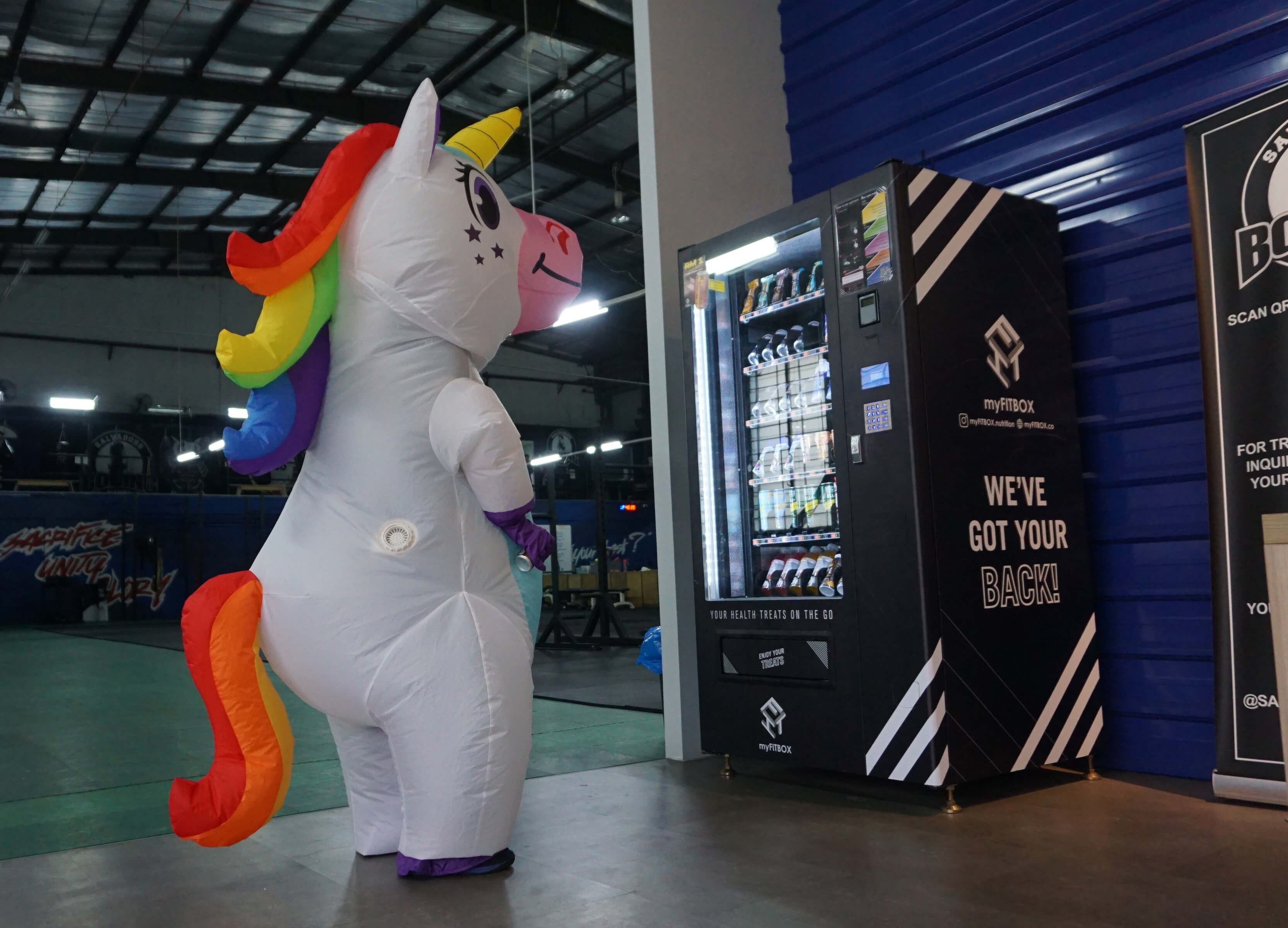 Peu Peu the Unicorn, the myFITBOX mascot, checking out one of the vending machines at D13 Gym in Petaling Jaya