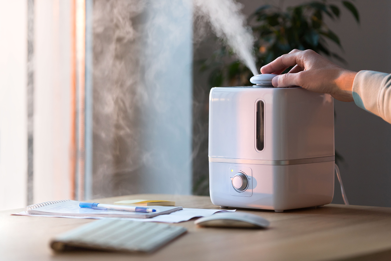 man-using-aroma-oil-diffuser-table-steam-from-air-humidifier-selective-focus.jpg