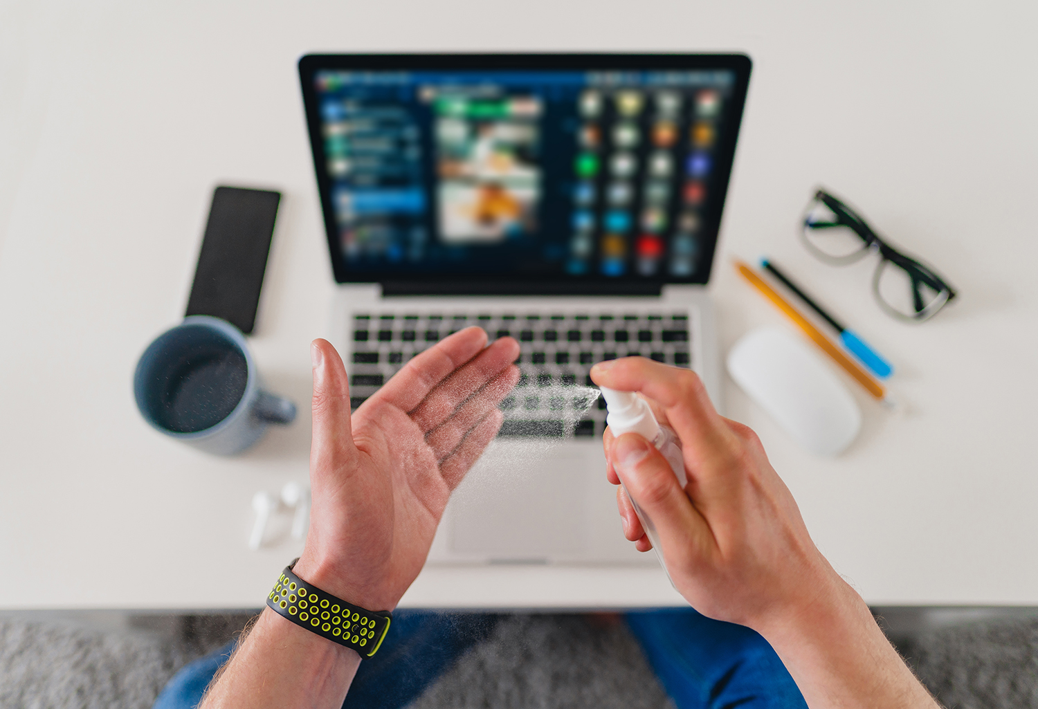 top-view-table-close-up-man-cleaning-hands-with-sanitizer-antiseptic-spray-workplace-home-working-laptop.jpg