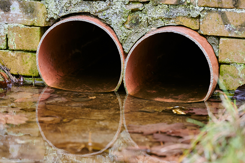 sewers-with-toxic-dirty-water-from-metal-pipes.jpg