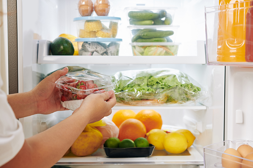 woman-putting-strawberries-fridge.jpg