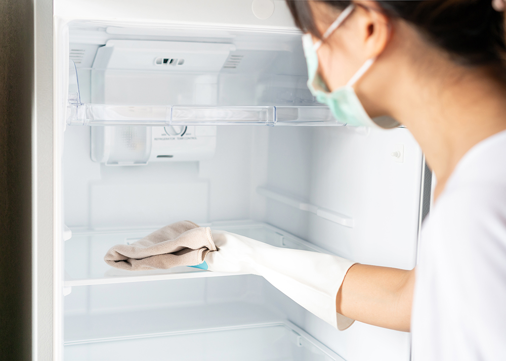 woman-wearing-medical-mask-glove-cleaning-white-empty-refrigerator-with-rag.jpg