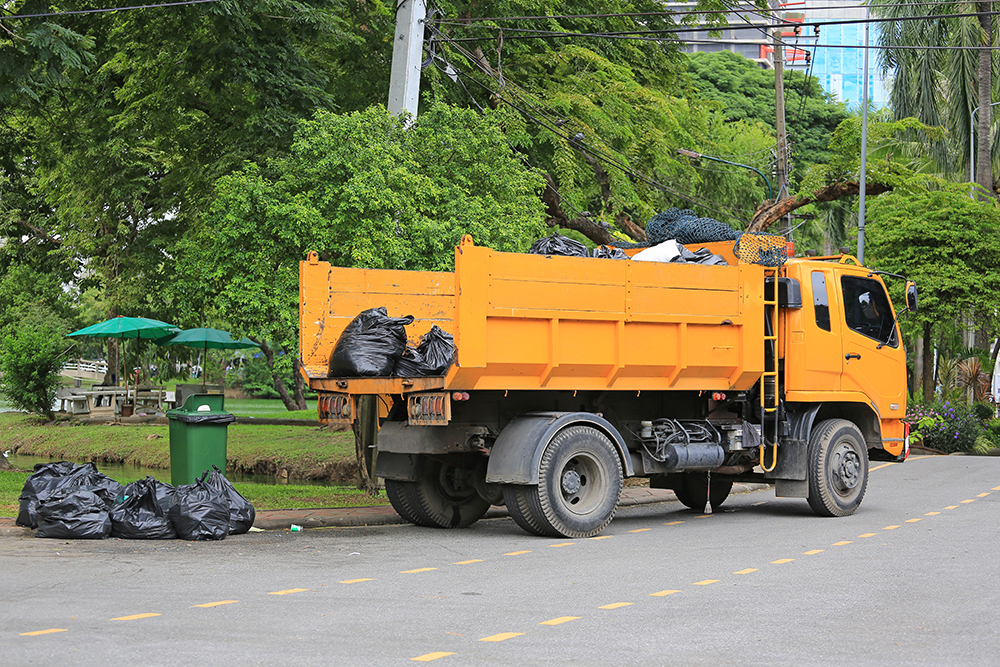 garbage-truck-with-loading-waste-park-garden.jpg