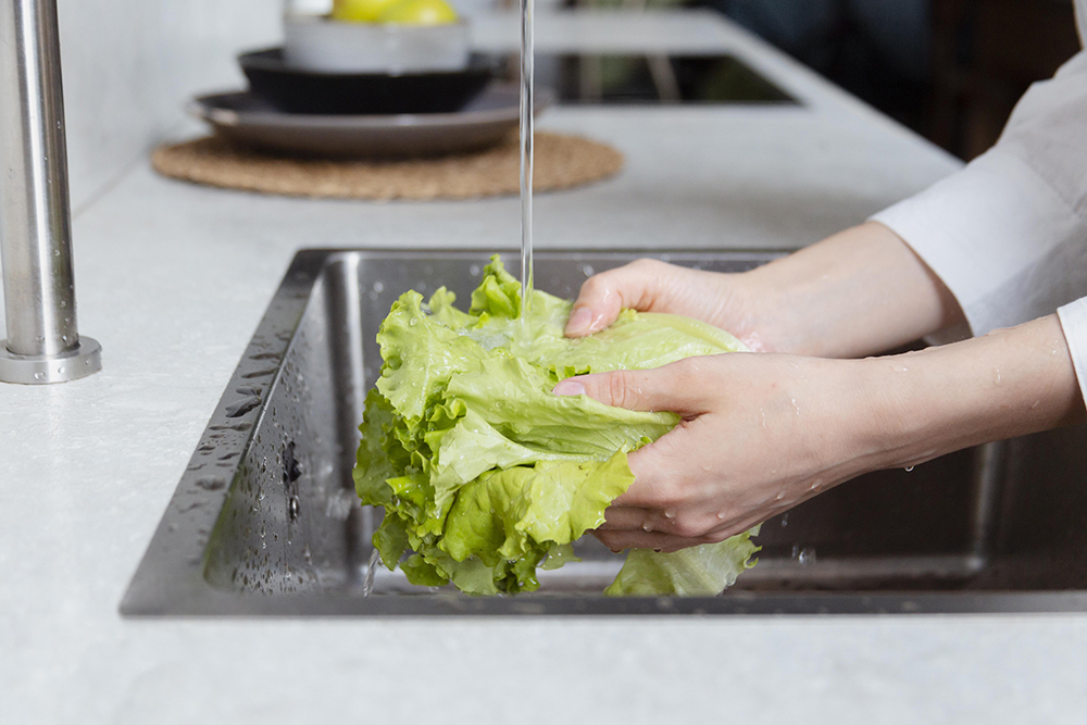 close-up-hands-washing-lettuce