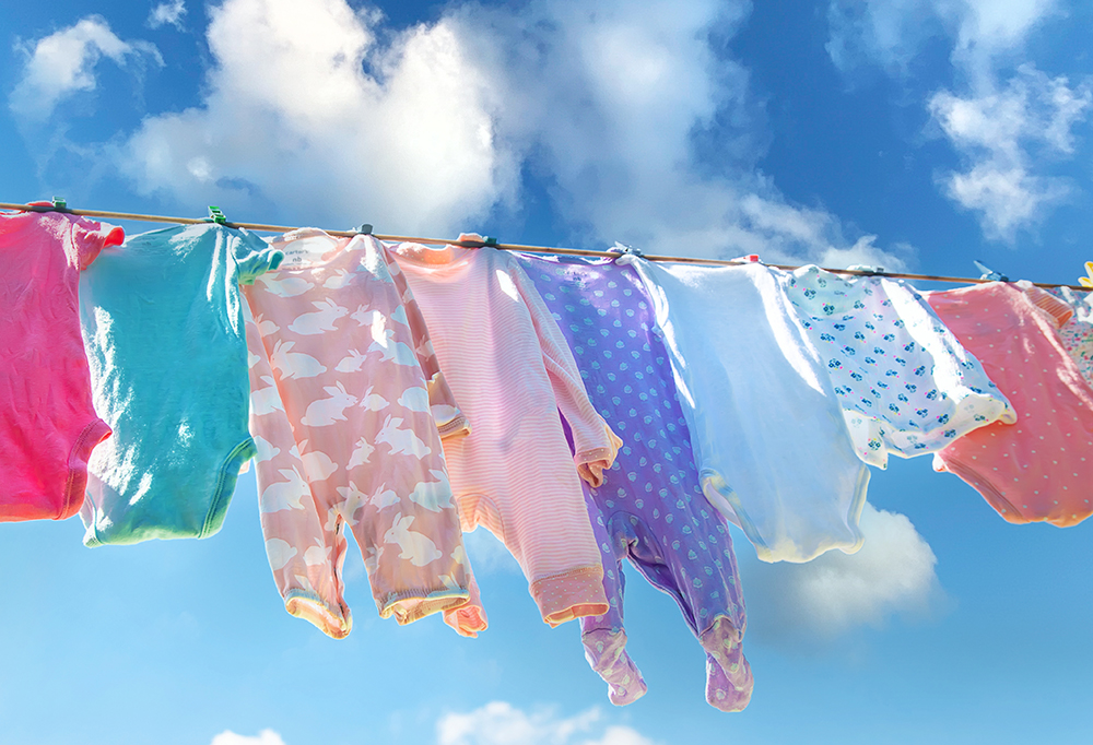 baby-clothes-are-drying-street-selective-focus