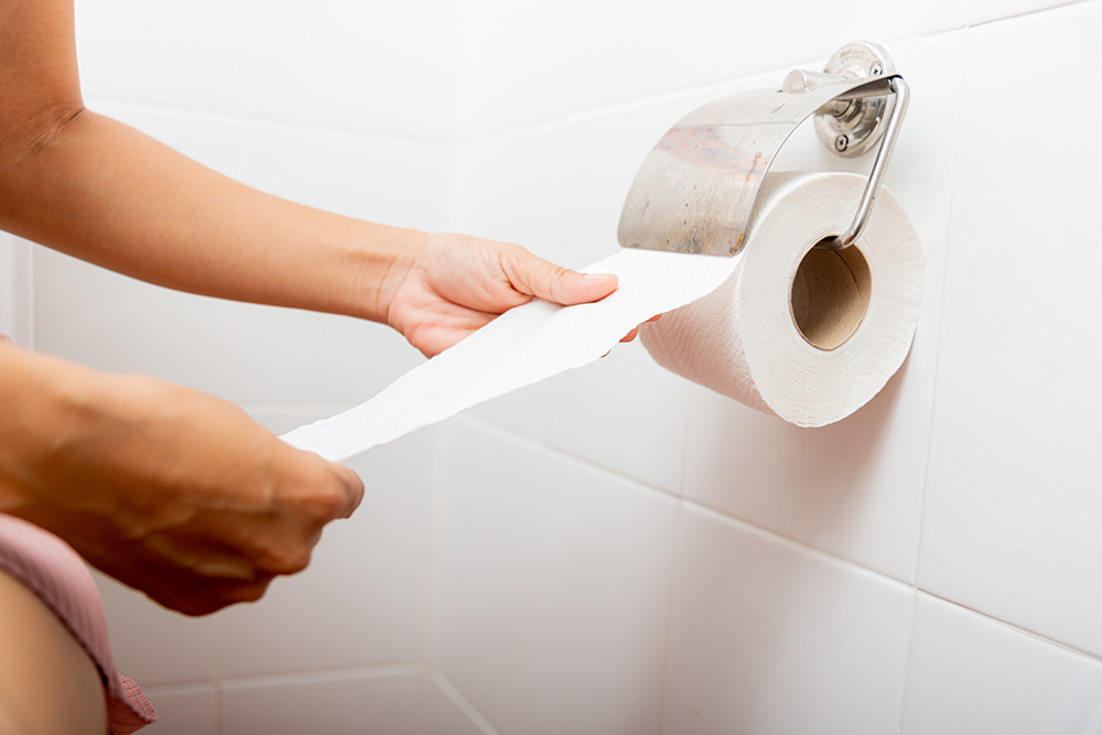 closeup-hand-pulling-toilet-paper-roll-holder-wipe