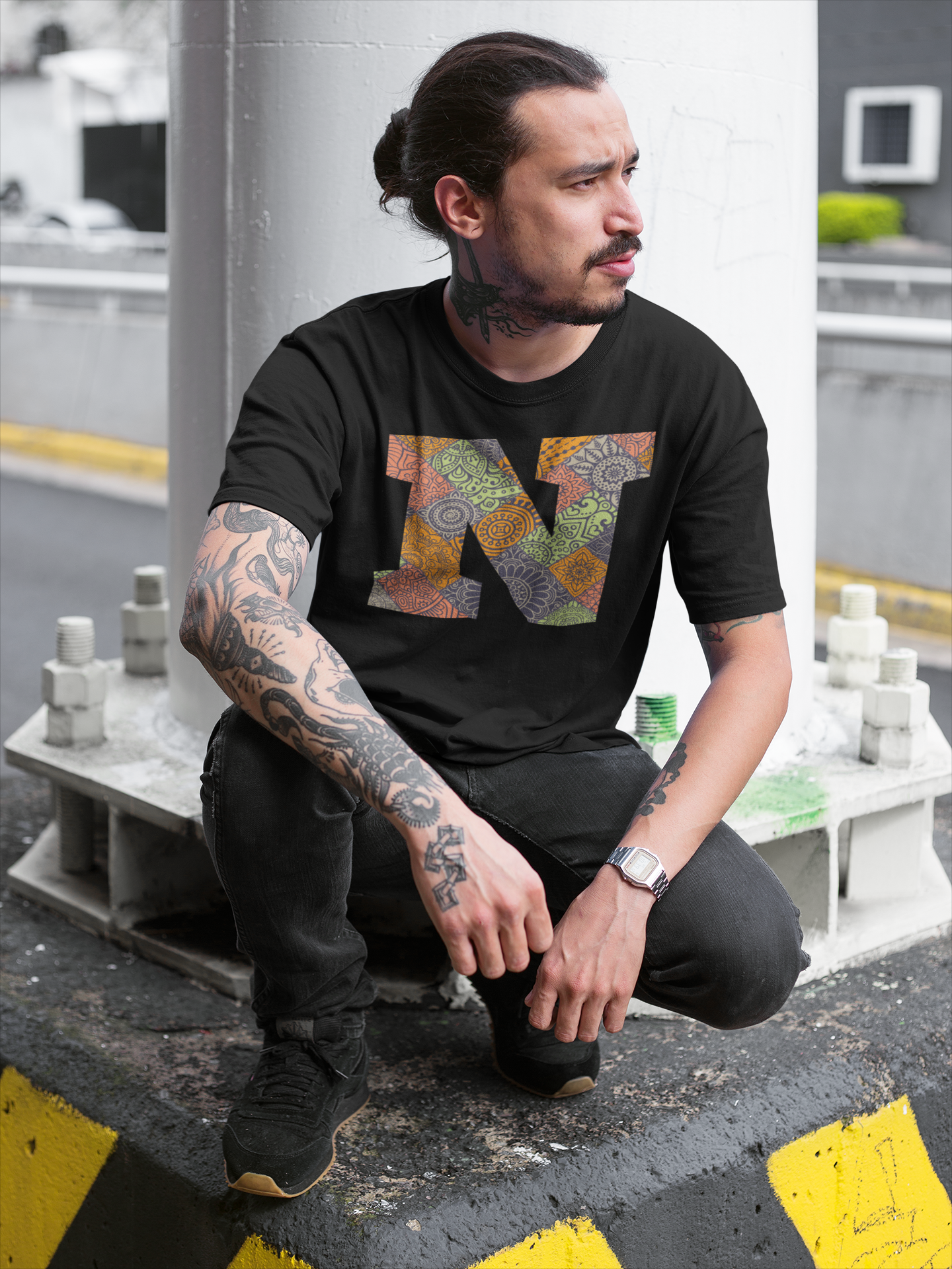 tattooed-man-wearing-a-round-neck-tee-mockup-while-crouching-under-a-bridge-a17078.png